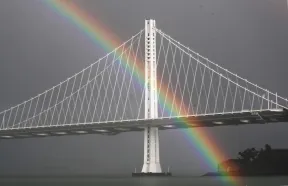 A rainbow appears behind the eastern span of the Bay Bridge during the eighth day of shelter in place seen from Treasure Island, San Francisco, Calif., on Tuesday, March 24, 2020. (Ray Chavez/Bay Area News Group)