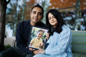 Deepak Nasta of San Jose, left, and his wife, Teena Punjwani, with a photo of their son, Jayaan Nasta, 5, who is receiving treatment for brain cancer, on Oct. 31, 2025, at Lucile Packard Children's Hospital at Stanford. (Dai Sugano/Bay Area News Group)