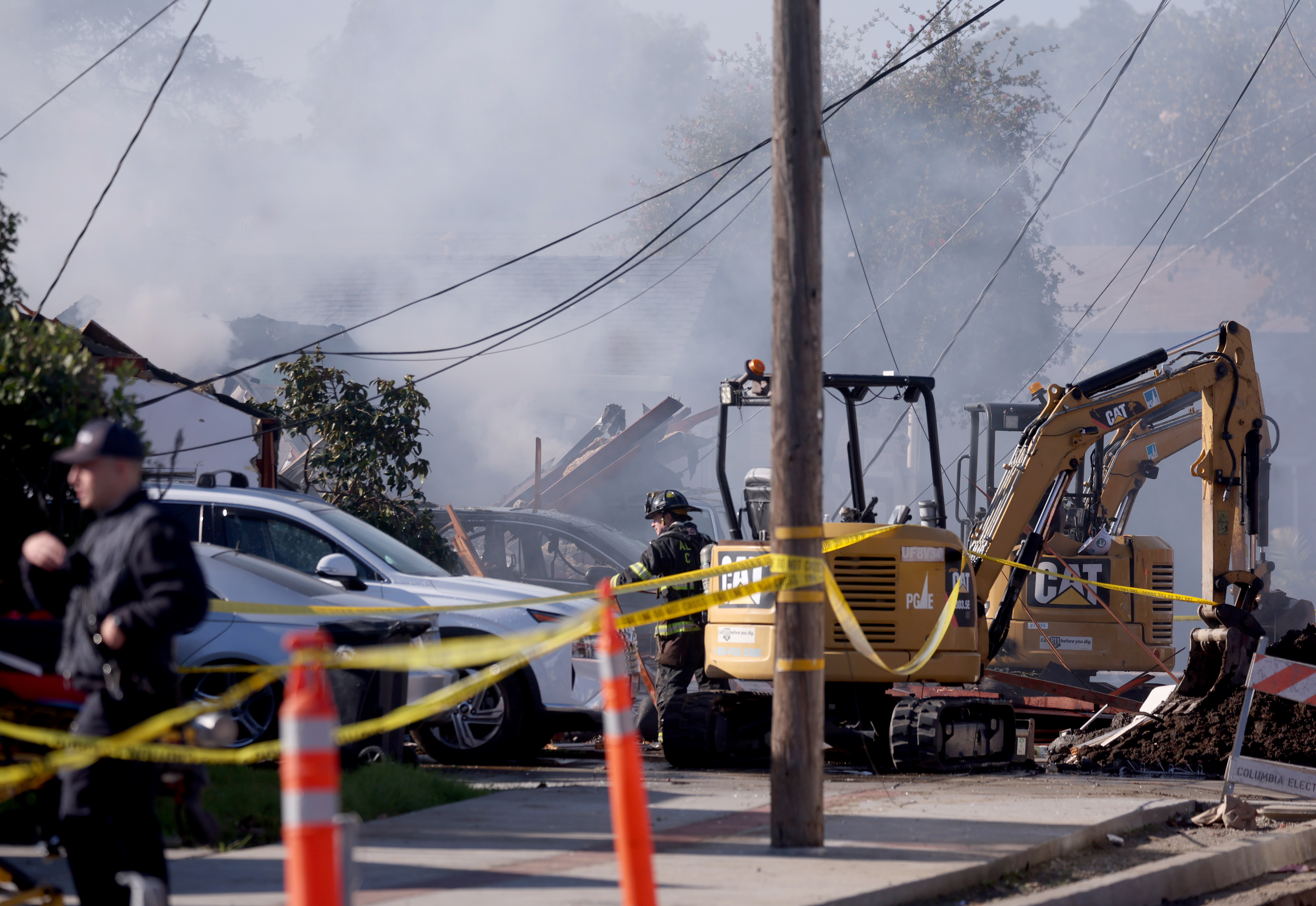 Construction equipment is seen as firefighters respond to a three-alarm fire on East Lewelling Boulevard in unincorporated Ashland, Calif., on Thursday, Dec. 11, 2025. Officials said that six people were transported to the hospital after a PG&E gas line explosion. (Jane Tyska/Bay Area News Group)