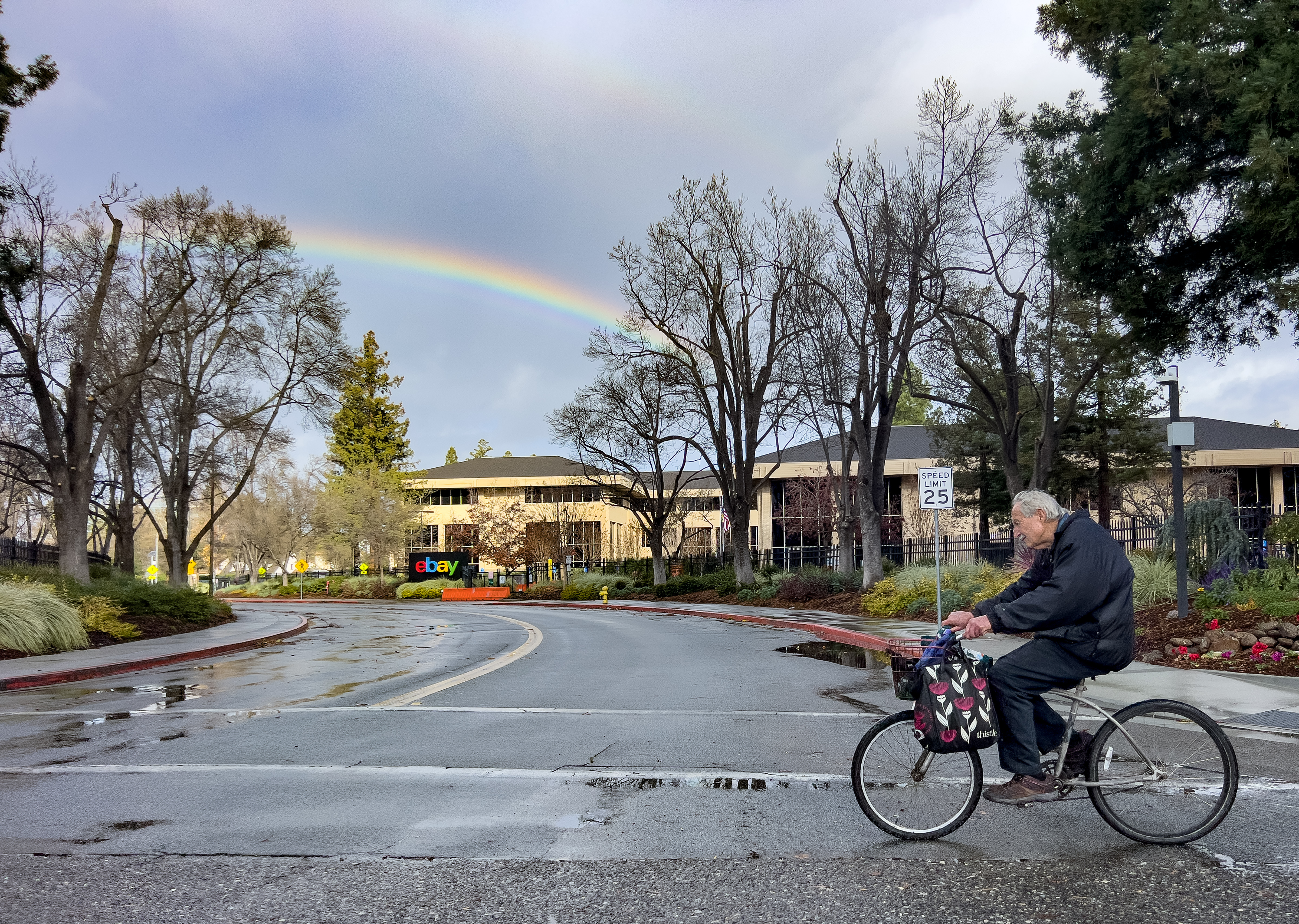 A man rides a bike as a rainbow streaks the sky in San Jose, Calif., on Friday, Dec. 26, 2025. (Shae Hammond/Bay Area News Group)