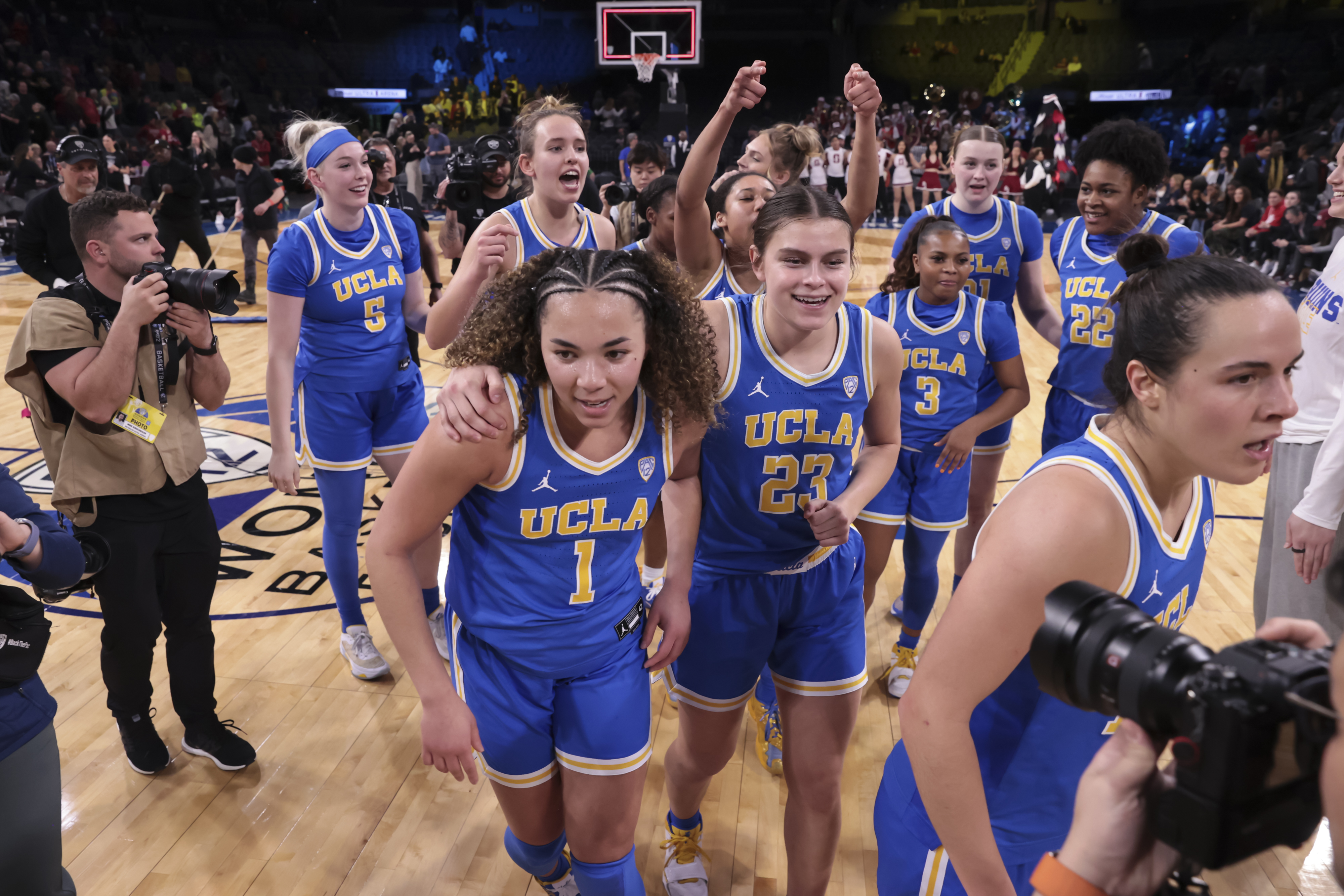 UCLA guard Kiki Rice (1) and forward Gabriela Jaquez (23) head off the court after defeating UCLA in an NCAA college basketball game in the semifinals of the Pac-12 women's tournament Friday, March 3, 2023, in Las Vegas. (AP Photo/Chase Stevens)