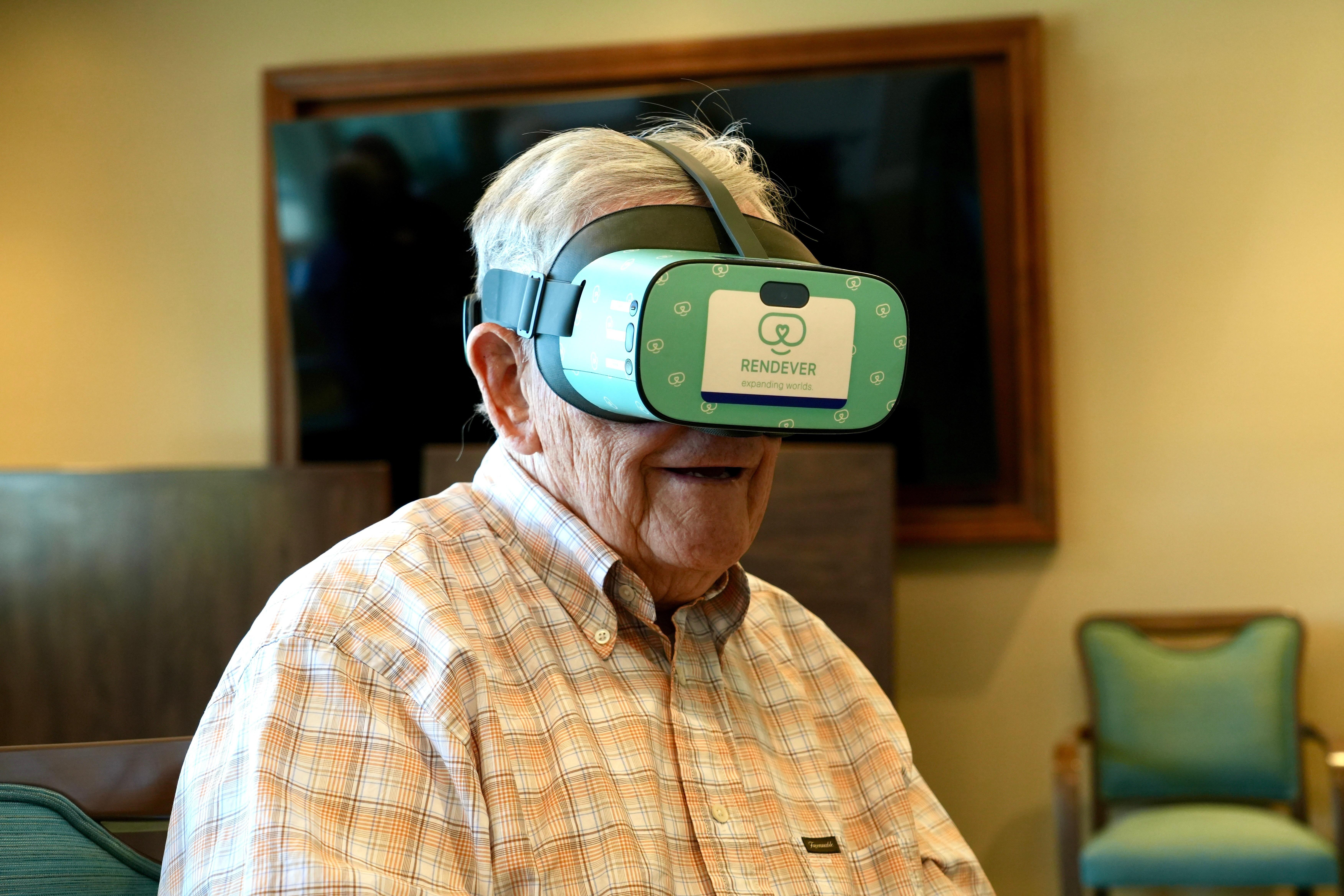 Jim Holtshouse watches video through a Rendever virtual-reality headset at...